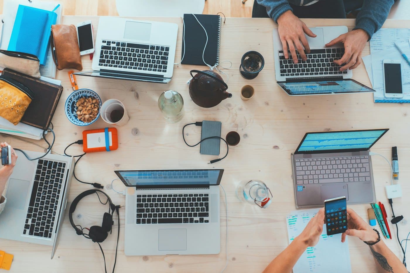 Team working together with laptops at a shared table